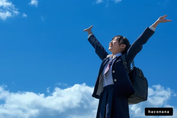 青空の下で喜ぶ学生